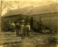 JW Diederich family and log house